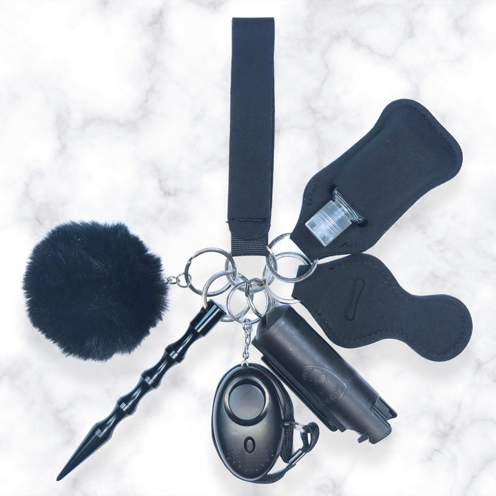 Black self-defense keychain set with pepper spray, kubuton, and alarm.