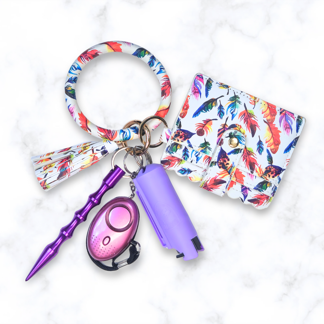 Feather ring bracelet safety keychain set with pepper spray, alarm, kubaton, and wallet.