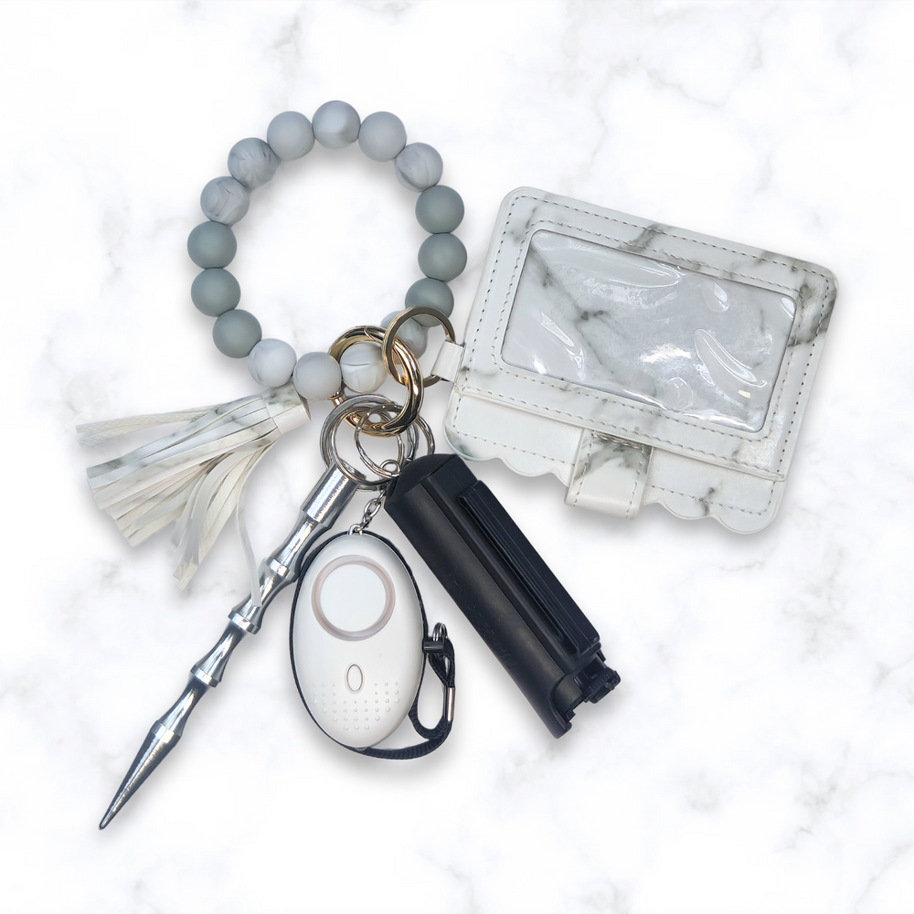 White marble wallet safety keychain set with panic alarm, kubaton, and pepper spray. 