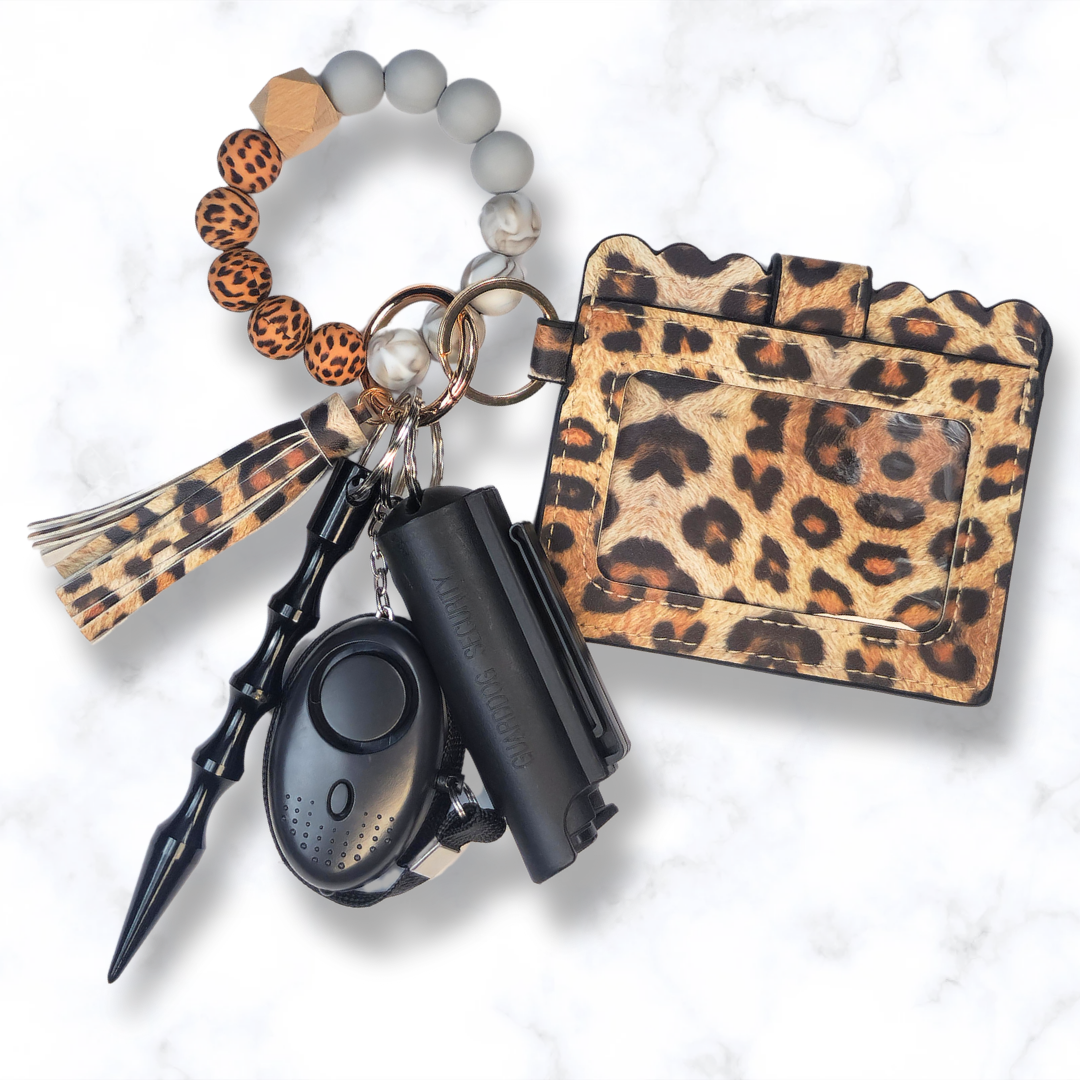 Cheetah print beaded safety keychain set with pepper spray, wallet, and alarm.
