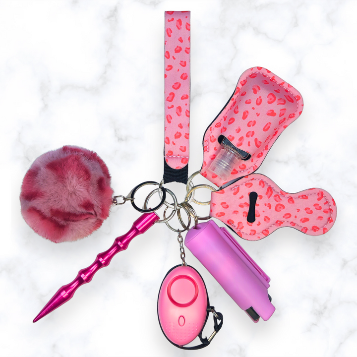 Pink leopard safety keychain set with pepper spray, kubaton, and panic alarm. 