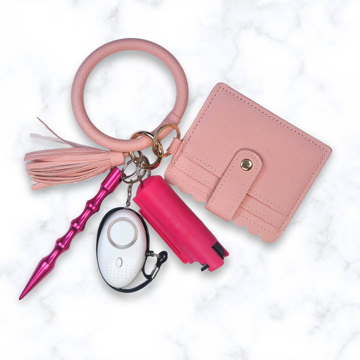 Pink ring bracelet safety keychain set with wallet, pepper spray, kubaton, and alarm. 