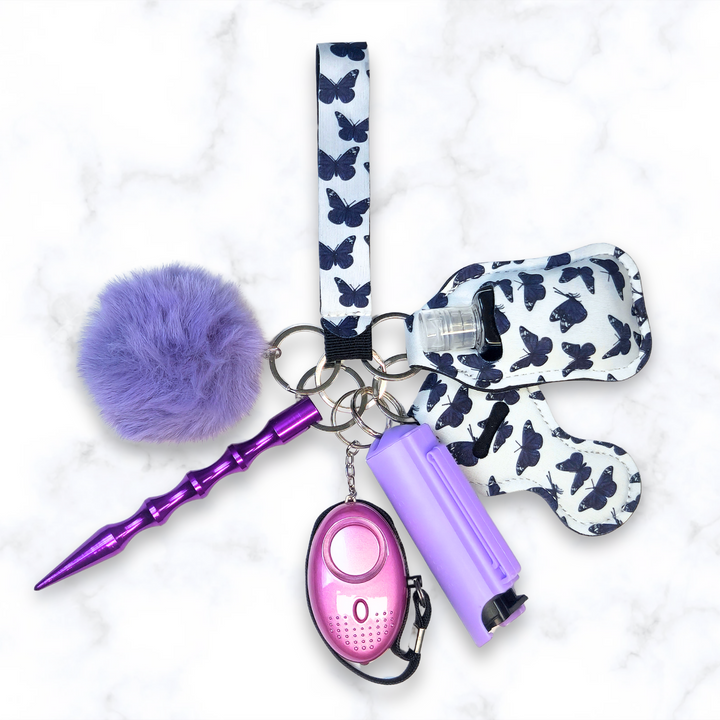 Purple butterfly safety keychain set with pepper spray, alarm, kubaton, and pom.