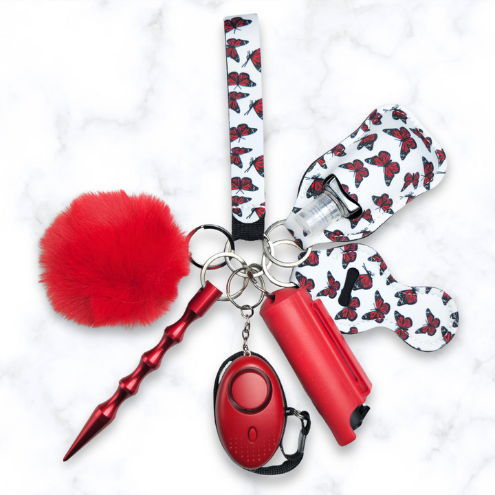 Red butterfly safety keychain set with pepper spray, alarm, kubaton, and pom pom.