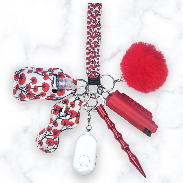 Red poppy safety keychain set with rechargeable alarm and pepper spray. 