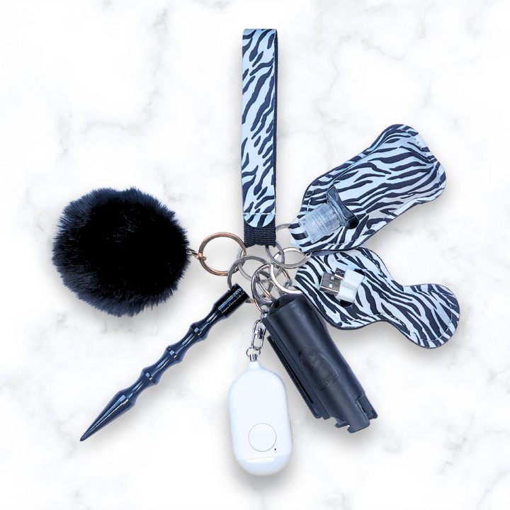 Zebra safety keychain set with pepper spray, kubaton, and personal alarm. 